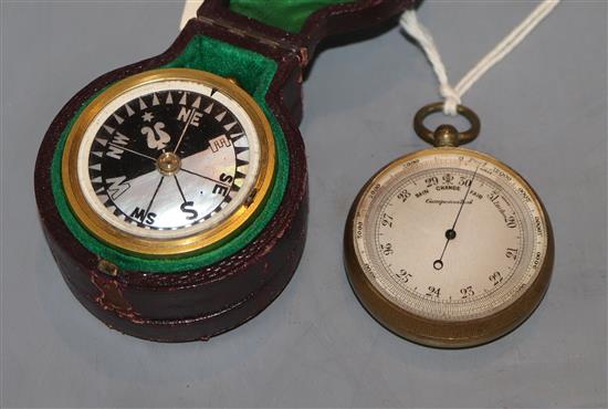 A cased pocket barometer / compass, together with a brass pocket barometer